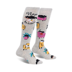 Pair of grey knee-high socks with black cats napping in armchairs and the words 'Nap Leisure'.  Features yellow and pink armchairs and palm trees.