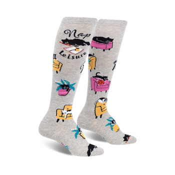 Pair of grey knee-high socks with black cats napping in armchairs and the words 'Nap Leisure'.  Features yellow and pink armchairs and palm trees.