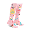 Pair of pink knee-high socks with a fun design featuring rockets, UFOs, crafting icons, and the text 'I Believe In Craft'.