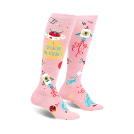 pink knee-high socks with repeating craft and alien-themed object pattern.  