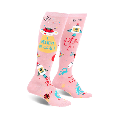 pink knee-high socks with repeating craft and alien-themed object pattern.  