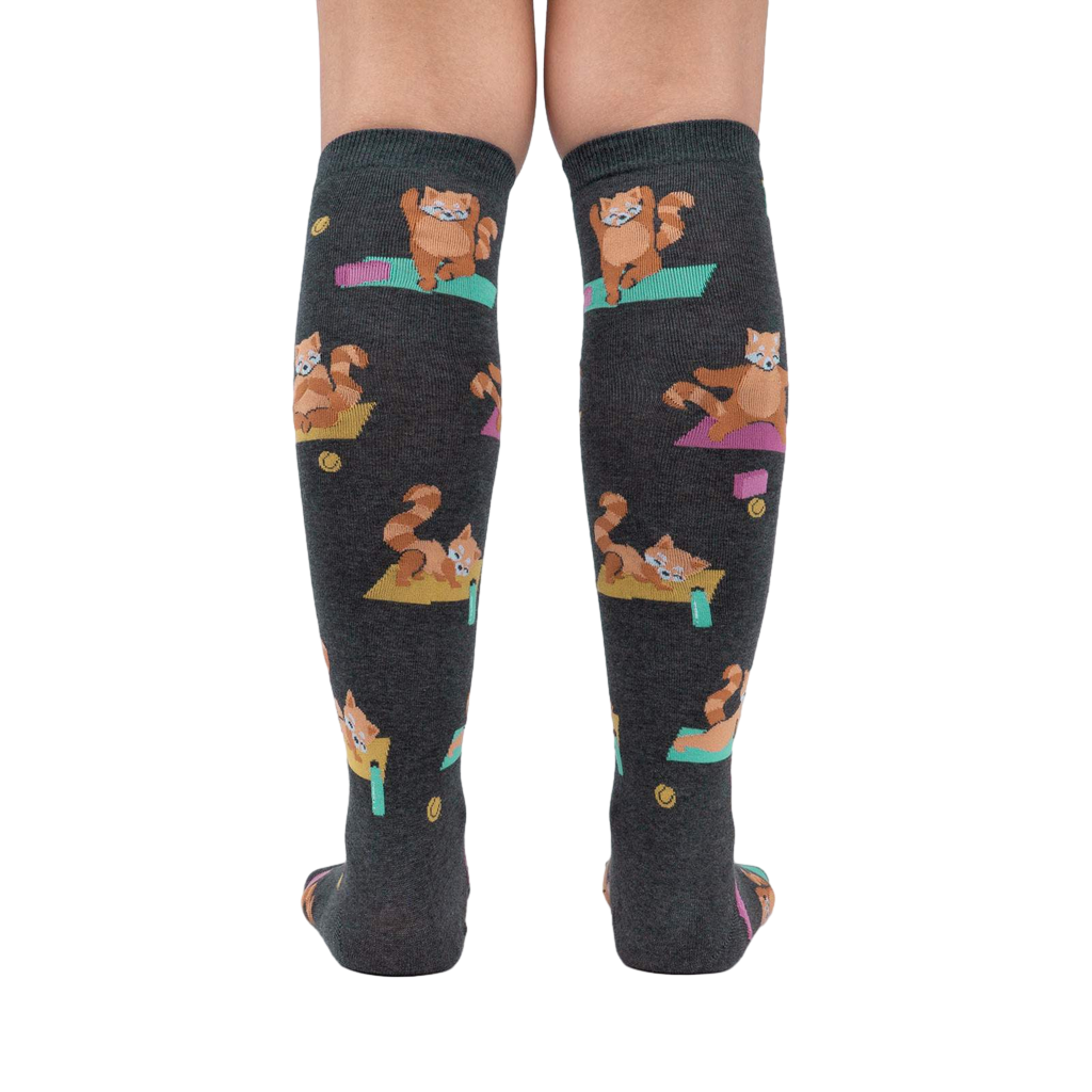 Rear view of a person wearing the Red Panda Pose knee-high socks, highlighting the full design and fit.