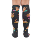 Rear view of a person wearing the Red Panda Pose knee-high socks, highlighting the full design and fit.