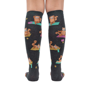 Rear view of a person wearing the Red Panda Pose knee-high socks, highlighting the full design and fit.