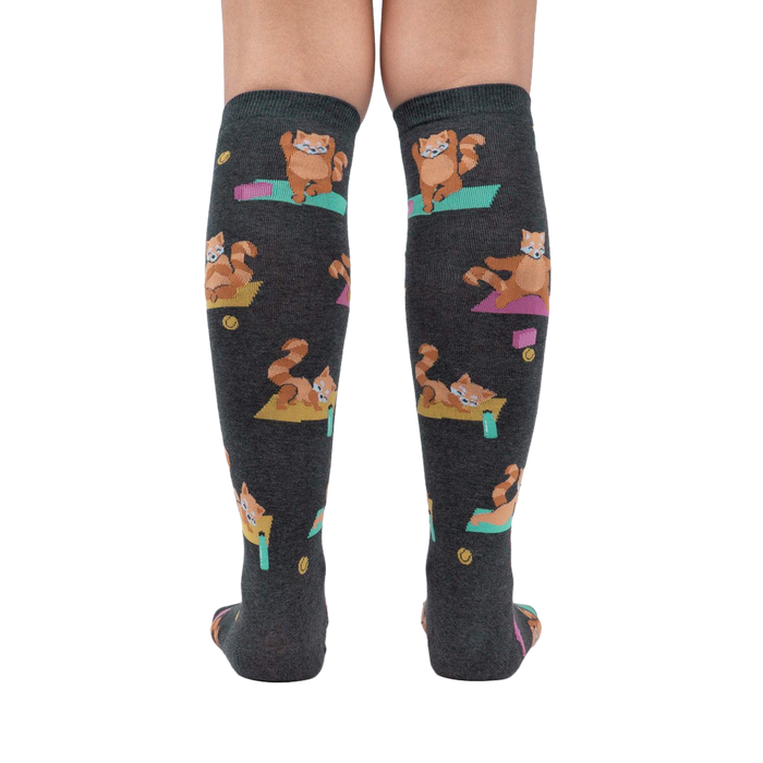 Rear view of a person wearing the Red Panda Pose knee-high socks, highlighting the full design and fit.