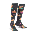 Pair of charcoal gray knee-high socks featuring a repeating pattern of red pandas doing yoga poses on teal yoga mats. 