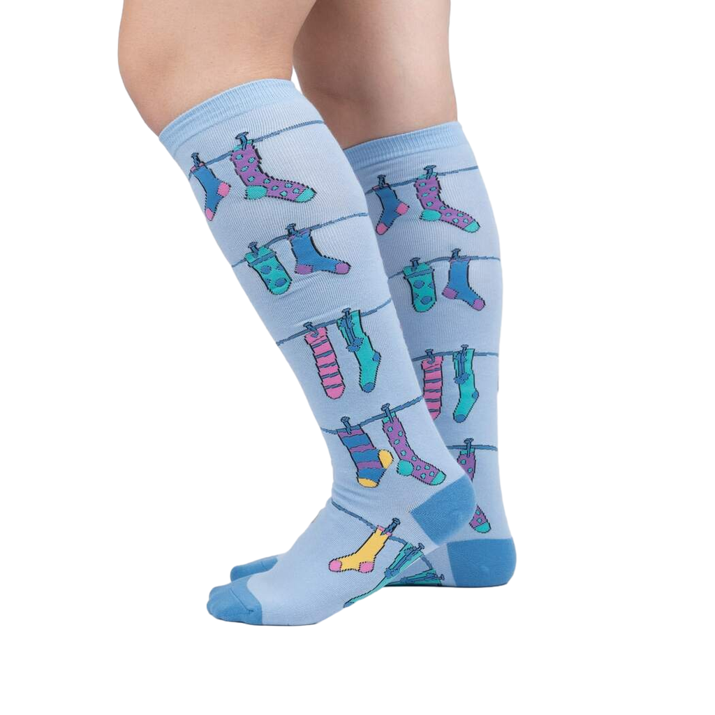 Lifestyle shot of a person wearing the Socks on Socks knee-high socks, showing the socks on their legs against a white background.