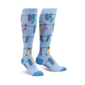 Pair of light blue knee-high socks with a pattern of colorful socks hanging on a clothesline. Fun and whimsical design.