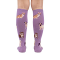 Back view of a person wearing the lavender purple knee-high socks. The dog illustrations are visible.