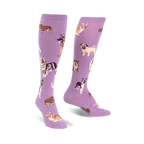 Pair of lavender purple knee-high socks featuring a pattern of various dog breeds in illustrated style.