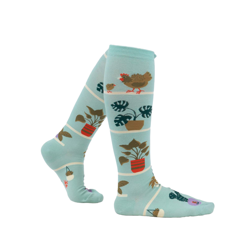 Lifestyle shot of a person wearing the Hen and Chicks knee-high socks, showing the socks from the side.