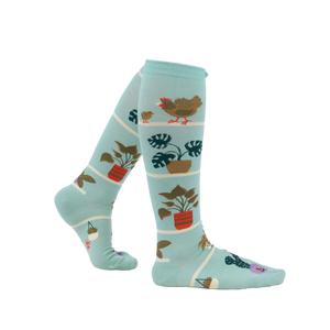 Lifestyle shot of a person wearing the Hen and Chicks knee-high socks, showing the socks from the side.