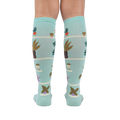 Back view of the Hen and Chicks knee-high socks on a person's legs, highlighting the full sock design.
