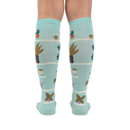 Back view of the Hen and Chicks knee-high socks on a person's legs, highlighting the full sock design.