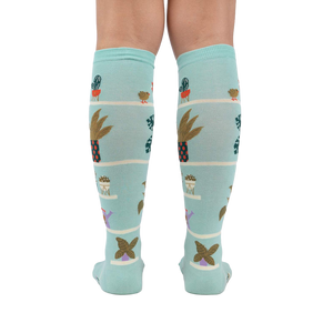 Back view of the Hen and Chicks knee-high socks on a person's legs, highlighting the full sock design.