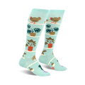 Pair of light teal knee-high socks featuring hens, chicks, and potted plants in a whimsical design.