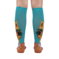 Rear view of the sunflower socks on a person's legs against a white background. The teal and sunflower design is clearly visible.