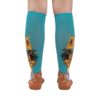 Rear view of the sunflower socks on a person's legs against a white background. The teal and sunflower design is clearly visible.