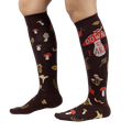 Lifestyle shot showing 'Down to Earth' knee-high socks on a person's legs, highlighting the fit and pattern.