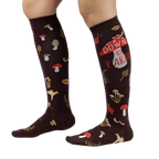 Lifestyle shot showing 'Down to Earth' knee-high socks on a person's legs, highlighting the fit and pattern.