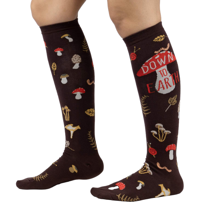 Lifestyle shot showing 'Down to Earth' knee-high socks on a person's legs, highlighting the fit and pattern.
