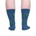 Rear view of model's legs wearing the blue crew socks with dancing pickle design.