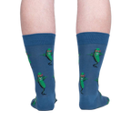 Rear view of model's legs wearing the blue crew socks with dancing pickle design.