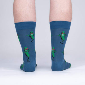 A pair of blue socks with a pattern of dancing pickles wearing sunglasses.