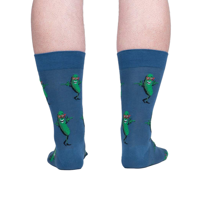 Rear view of model's legs wearing the blue crew socks with dancing pickle design.