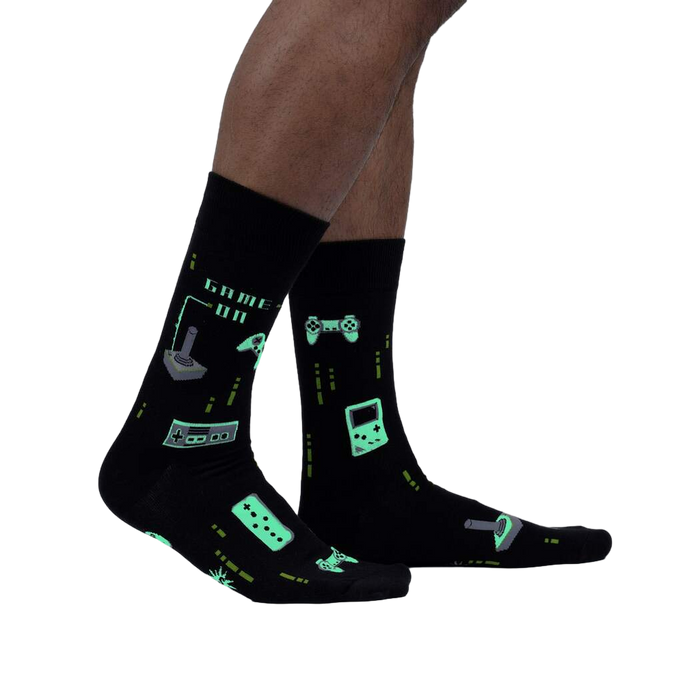 Close-up of the 'Game On' socks, highlighting the glowing details in the dark. The image emphasizes the glow-in-the-dark feature.