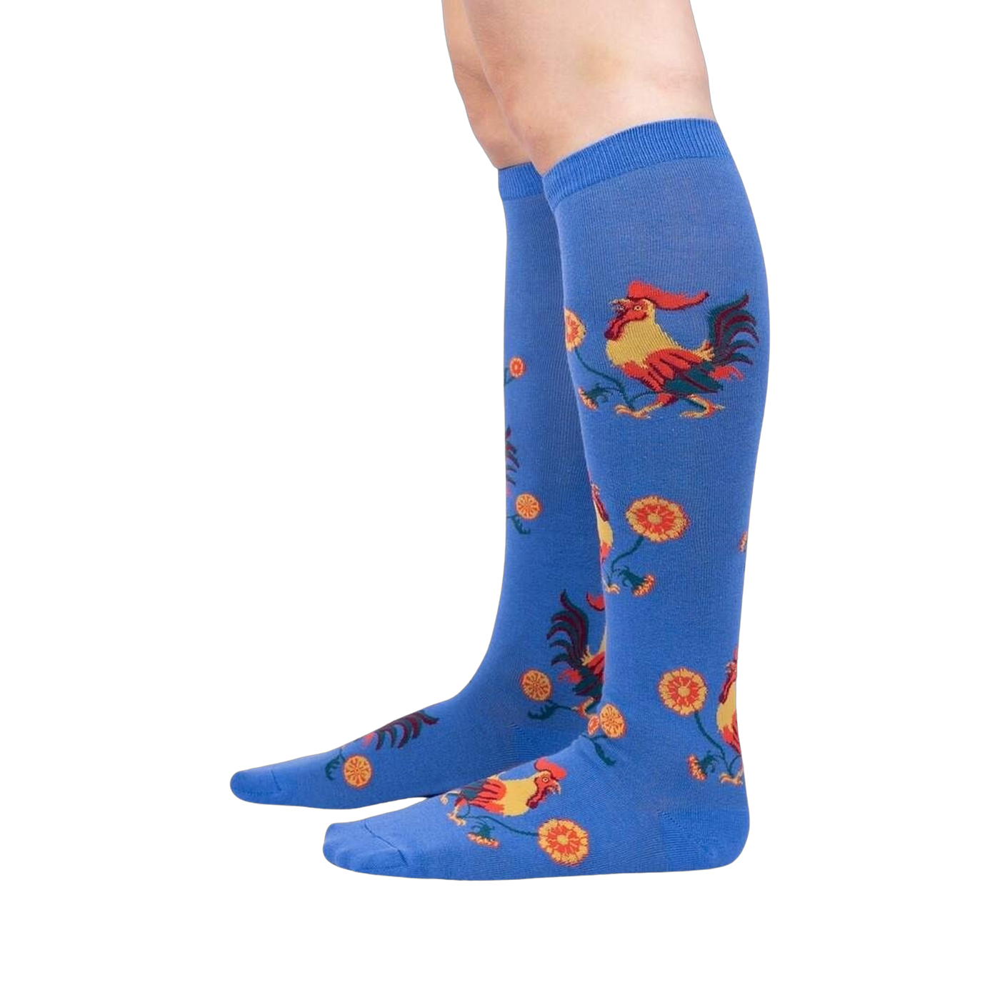 Lifestyle shot of Rise and Shine knee-high socks on a person's legs against a black background.