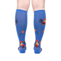 Rear view of model wearing Rise and Shine knee-high socks; showcasing the full sock design.