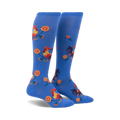 Pair of blue knee-high socks with a repeating pattern of roosters and yellow flowers.  Fun and colorful!