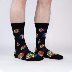 A pair of black socks with a pattern of colorful Rubik's Cubes.