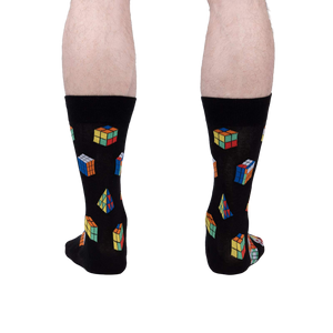 Rear view of a person's legs wearing the Puzzle Box socks, showcasing the full design on the back of the socks.