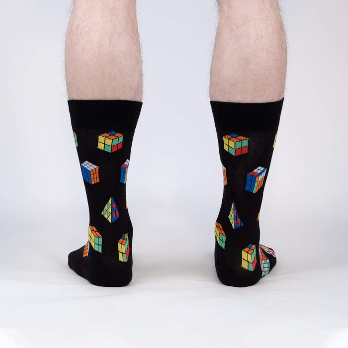 A pair of black socks with a pattern of colorful Rubik's Cubes.