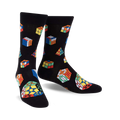 Pair of black crew socks adorned with multicolored Rubik's Cubes and geometric shapes. Fun, playful design.
