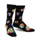 Pair of black crew socks adorned with multicolored Rubik's Cubes and geometric shapes. Fun, playful design.