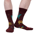 Lifestyle shot of a model's legs wearing the Beasts of Yore socks, showing the socks on feet.