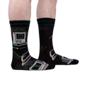 A lifestyle shot showcasing the 'Control Alt Delete' socks on a person's legs, highlighting the sock's fit and design on a model.