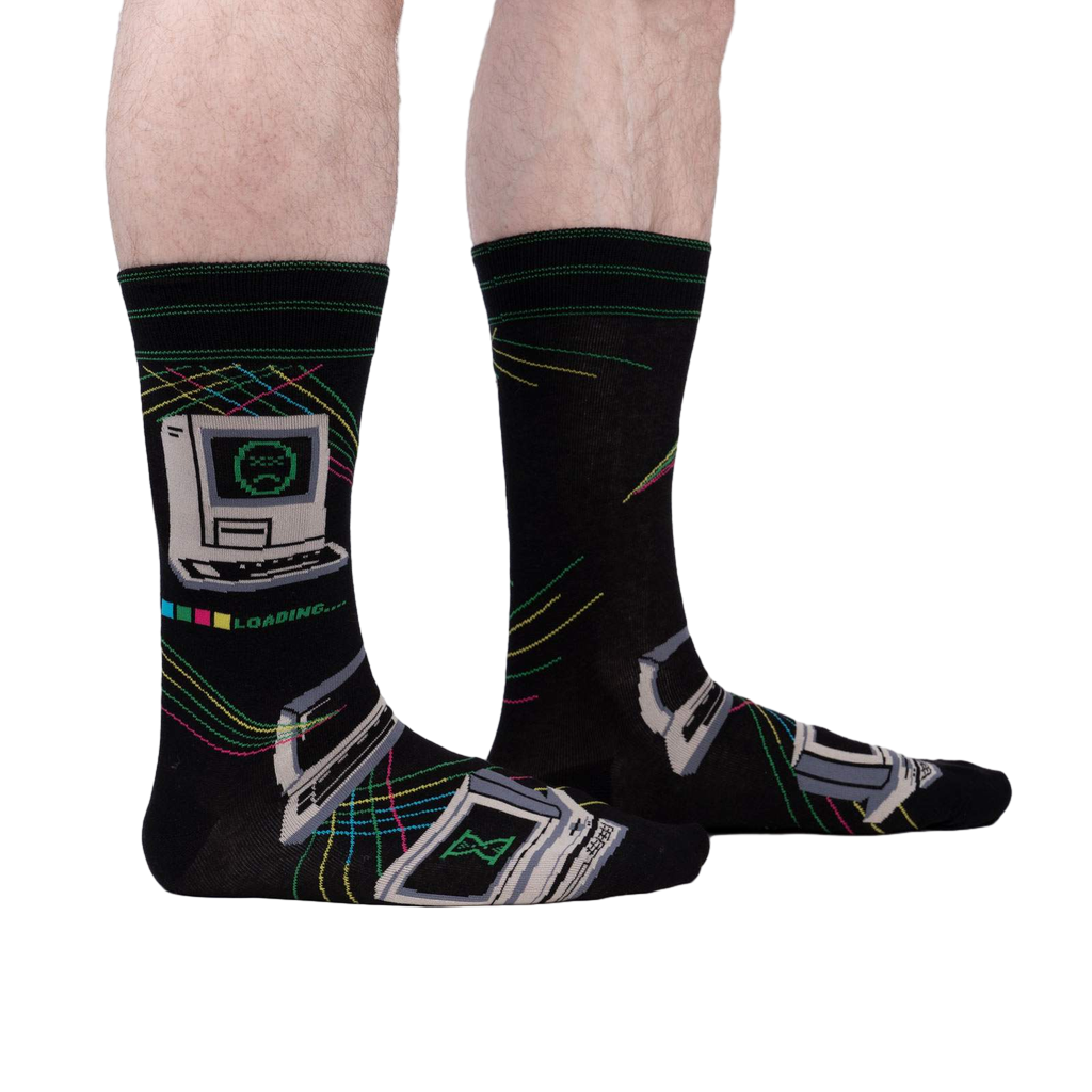 A lifestyle shot showcasing the 'Control Alt Delete' socks on a person's legs, highlighting the sock's fit and design on a model.