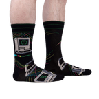 A lifestyle shot showcasing the 'Control Alt Delete' socks on a person's legs, highlighting the sock's fit and design on a model.