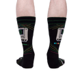 A rear view of the 'Control Alt Delete' socks on a person's legs, showcasing the sock design from behind.