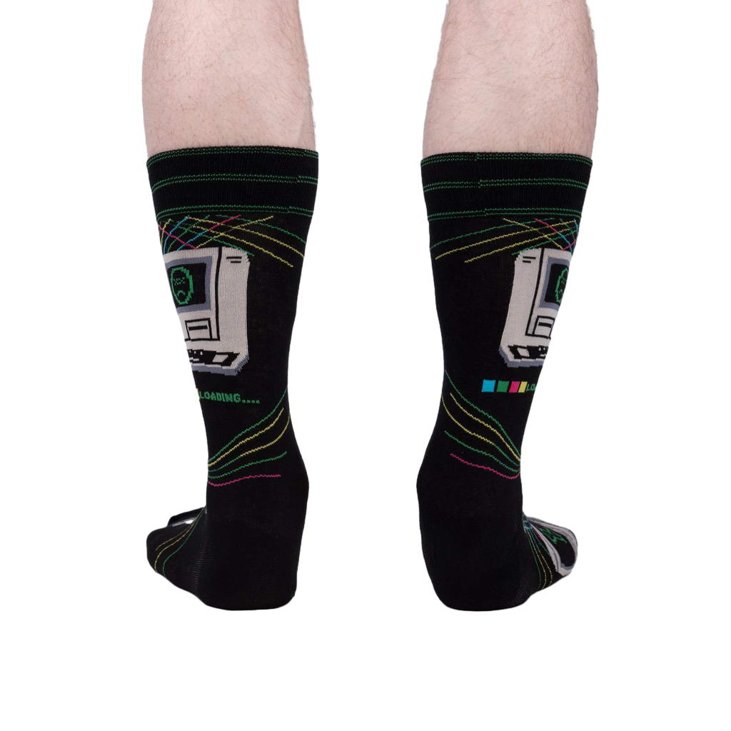 A rear view of the 'Control Alt Delete' socks on a person's legs, showcasing the sock design from behind.