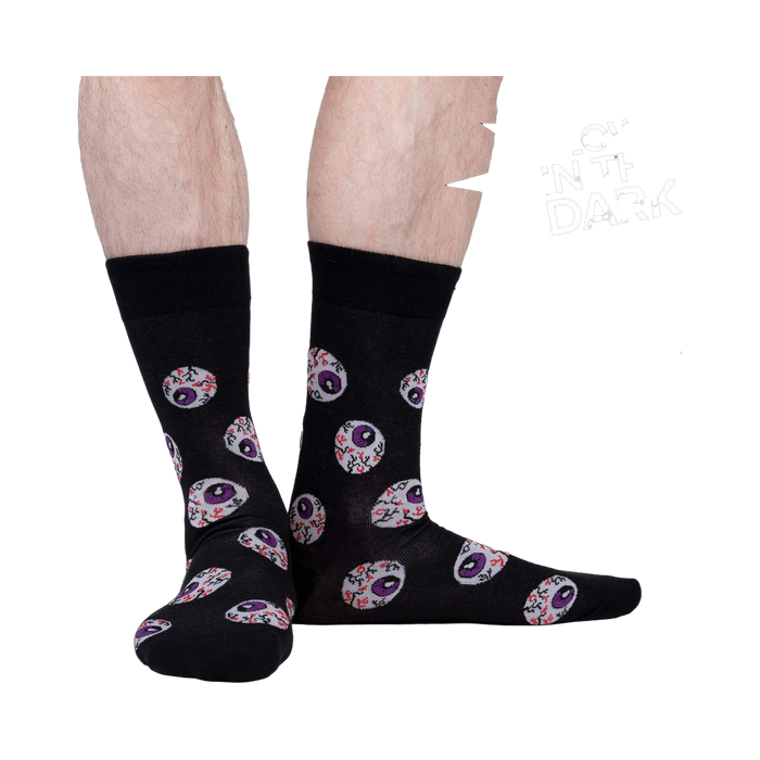 Lifestyle shot showing the glow-in-the-dark eye socks on a person's legs.