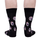 Rear view of a pair of black crew socks with an eyeball pattern.