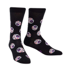 Black crew socks with a repeating pattern of purple and red eyeball designs. The socks glow in the dark.