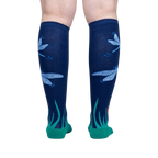 Back view of a person wearing the 'Dragonfly by Night' knee-high socks, showcasing the full design.