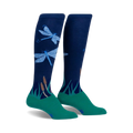 Pair of navy blue knee-high socks with teal cuffs, featuring a design of light blue dragonflies and green reeds.