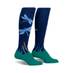 Pair of navy blue knee-high socks with teal cuffs, featuring a design of light blue dragonflies and green reeds.
